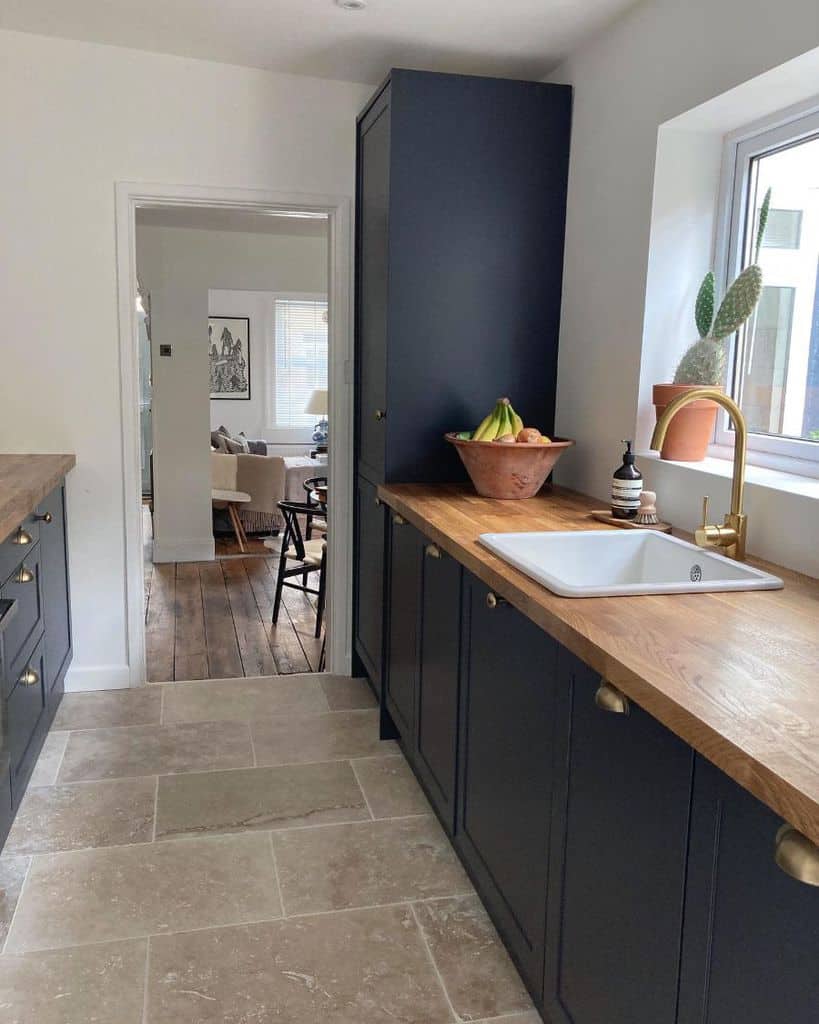 blue cabinet kitchen wood countertop gray slate floor tiles 