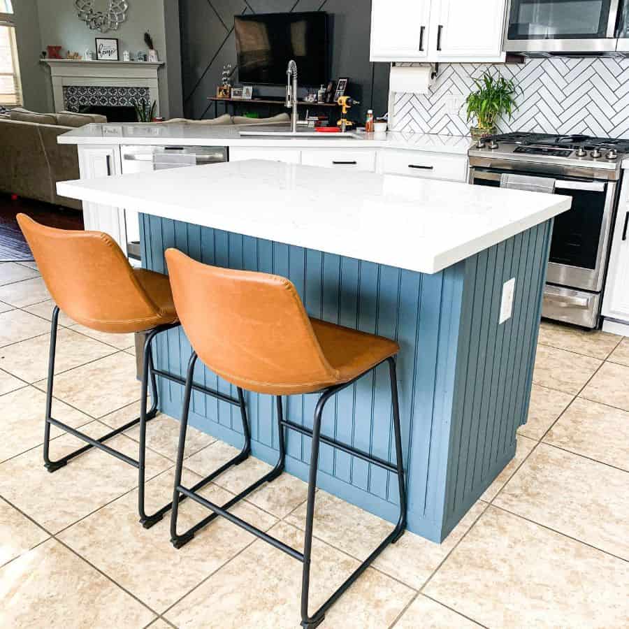 rustic country kitchen blue island two tan chairs white subway backsplash tiles 