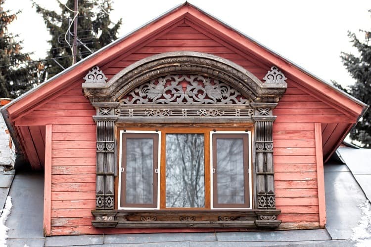 brown wooden ornate exterior window trim red wood planks 