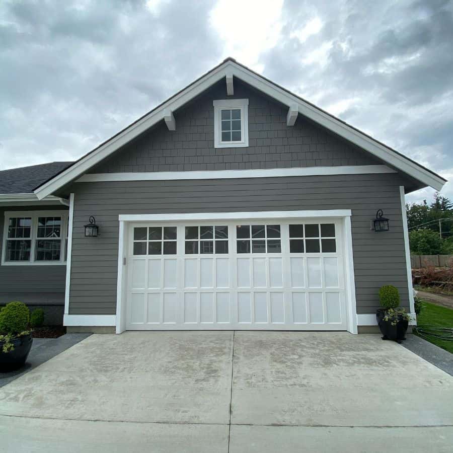 gray bungalow craftsman style house concrete driveway 