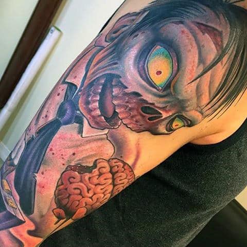 Cartoon Style Tattoo Of Zombie With Brain On Mans Arm