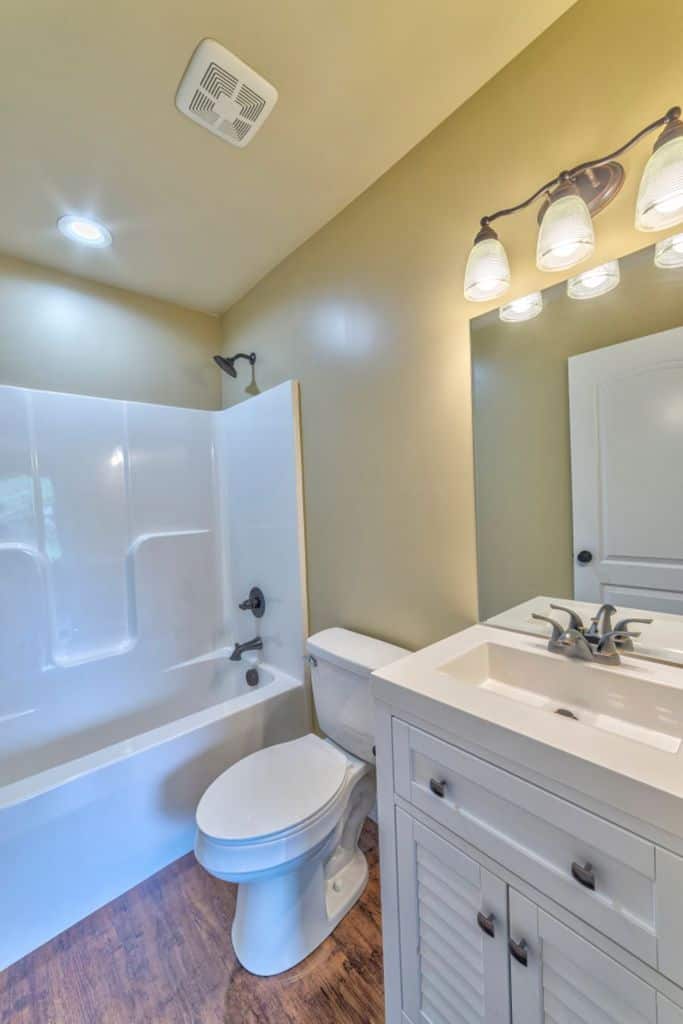 small bathroom with white shower and toilet 