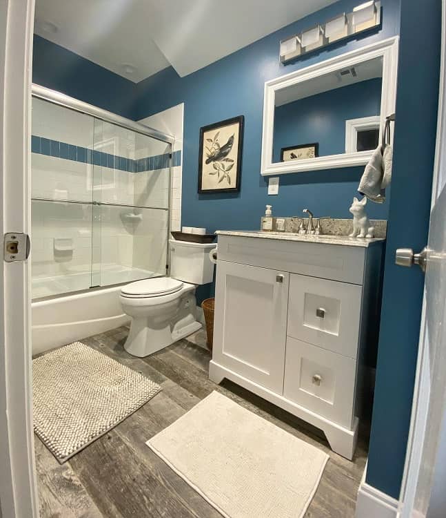 blue wall bathroom with white vanity 