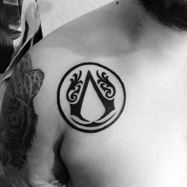Circle Assassins Creed Logo Male Upper Chest Tattoo