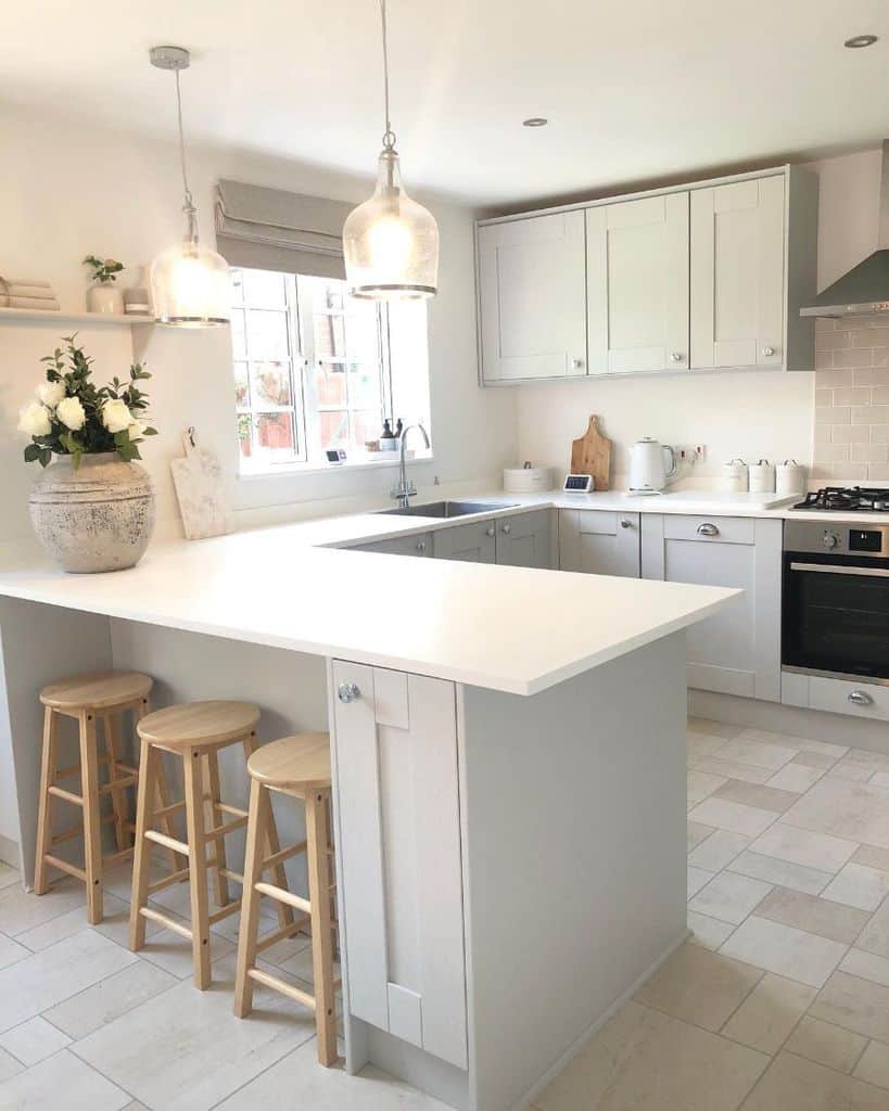 all-white country kitchen white floor tiles three wooden stools 