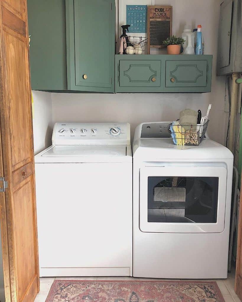 closet laundry room green cabinets washer and dryer