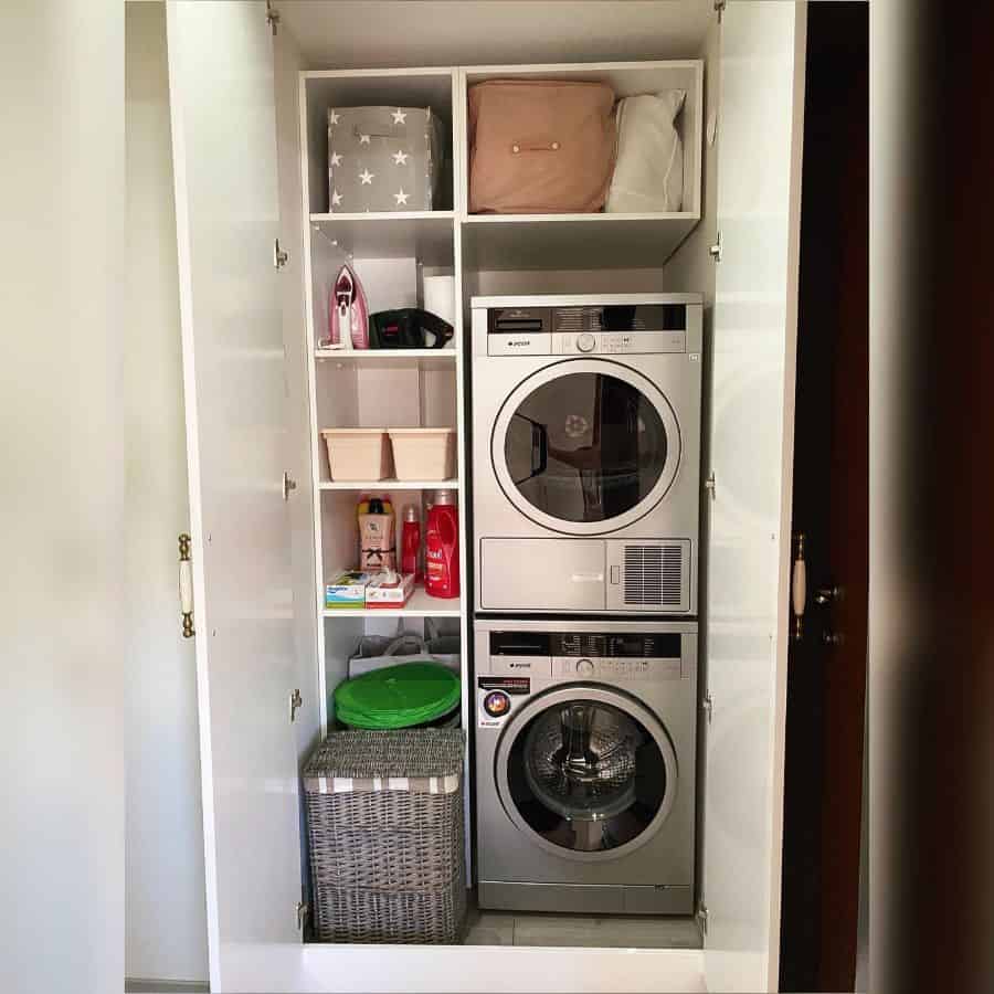 closet laundry room stacked washer and dryer