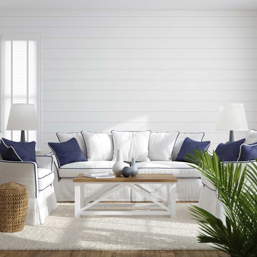 white shiplap walls white and blue couch modern living room 