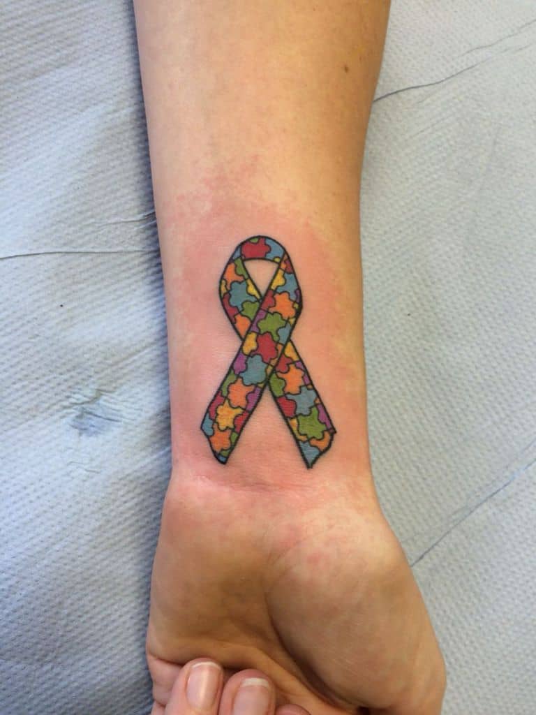 Full color wrist tattoo of Autism Awareness Puzzle ribbon