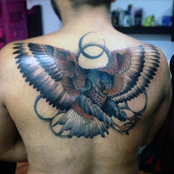 Colorful Hawk Surrounded By Circles Tattoo On Males Back