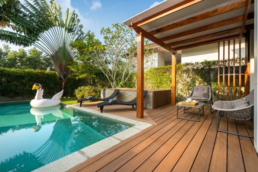 wood pool deck with sun loungers 