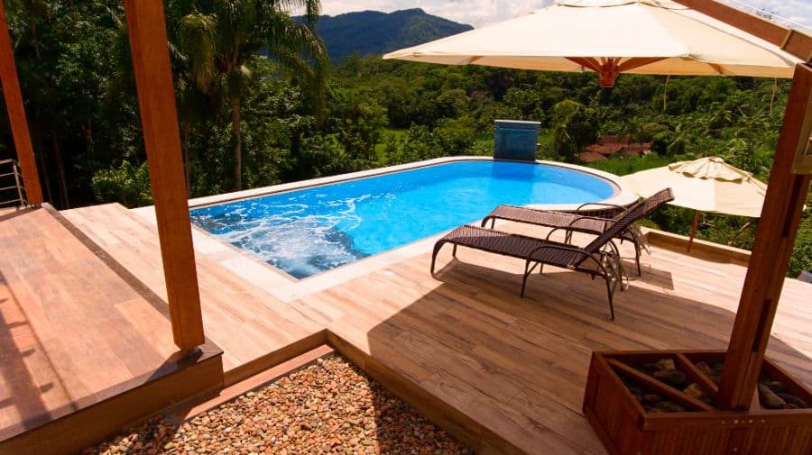 composite wood deck pool with sun loungers 