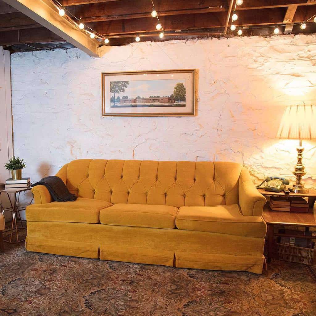 mustard couch in rustic lounge