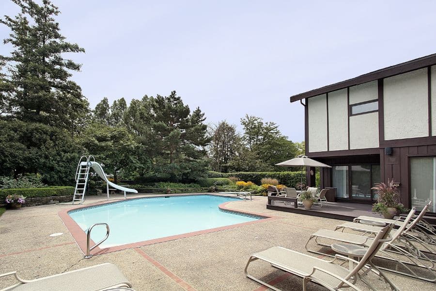 concrete pool deck patio with waterslide 