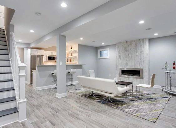 contemporary white basement kitchen living space fireplace 