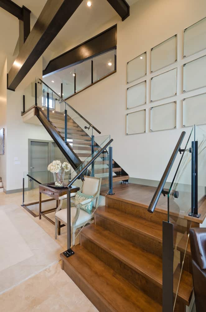 modern wood staircase with glass wall art