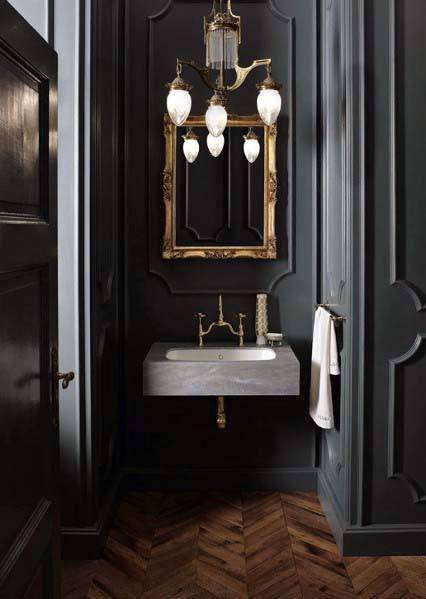 black bathroom with gold fixtures 