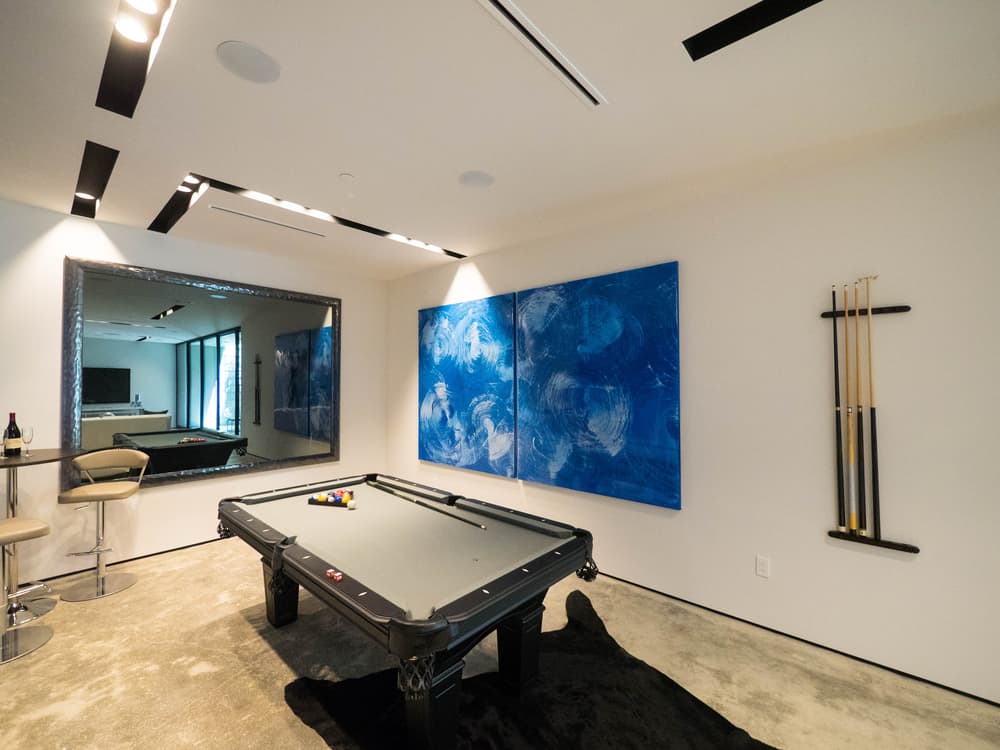 billiard table in games room with blue painting wall art