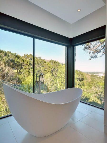 freestanding white bathtub with views of the countryside