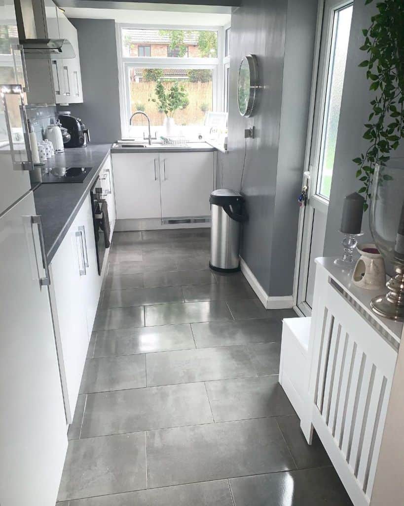 small corner kitchen white cabinets gray countertops tile flooring 