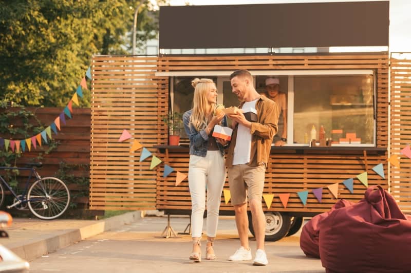 couple eat at a food truck