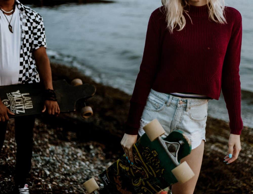 couple holding skateboards