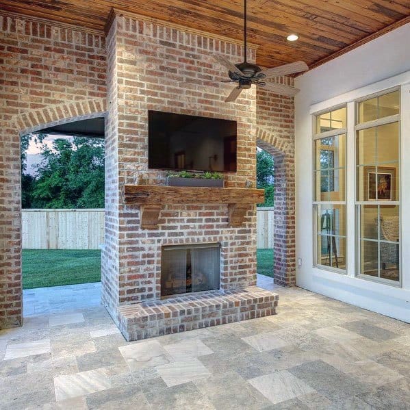 Covered Brick Patio Fireplace With Wood Ceiling