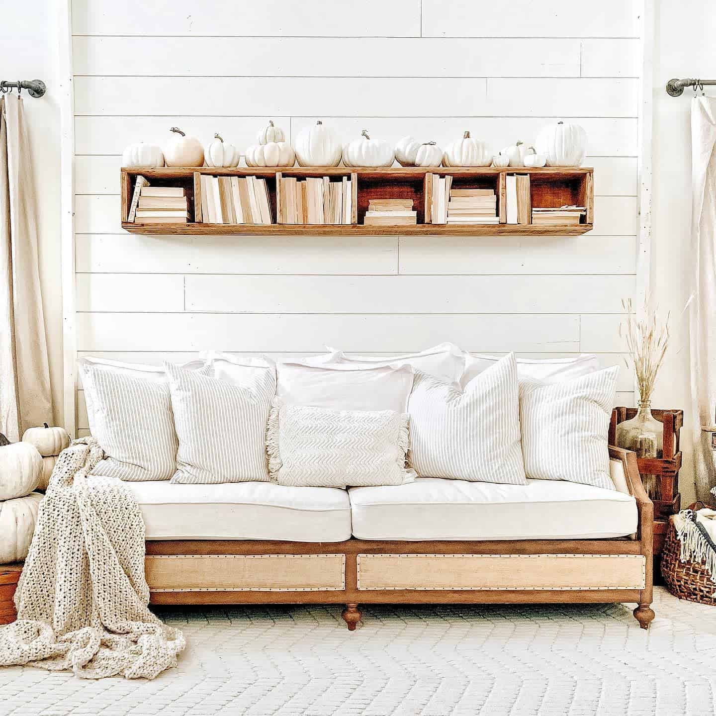 shiplap wall bookshelf with pumpkin decoration white cozy sofa 