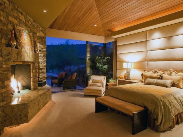 cabin bedroom wood ceiling stone fireplace 