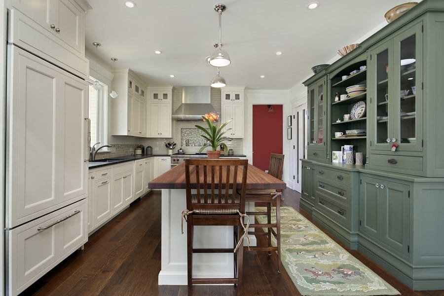 large farmhouse kitchen white and green cabinets wood countertop island 
