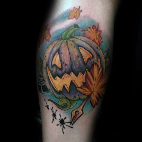 Creative Pumpkin With Fall Leaves Blowing In The Wind Tattoo For Men On Arm