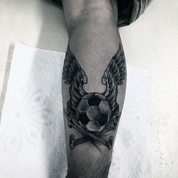 Crossbones And Angel Wings With Soccerball Mens Leg Tattoo