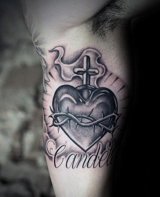 Black and grey sacred heart tattoo on the inner arm