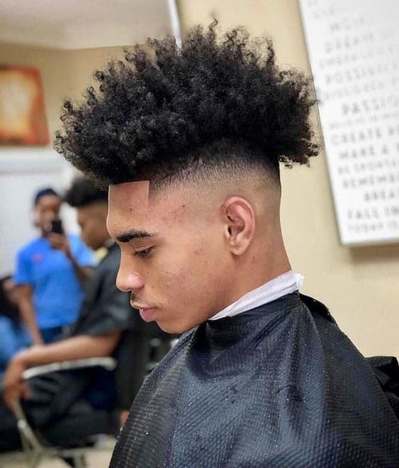 A frohawk with highly textured hair on top paired with clean-shaved sides