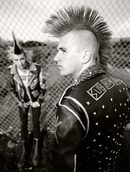 A cyberpunk Mohawk with puffed hawk on top and tapered sides