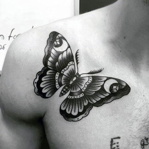 large black and grey traditional tattoo on man's shoulder of a dark butterfly