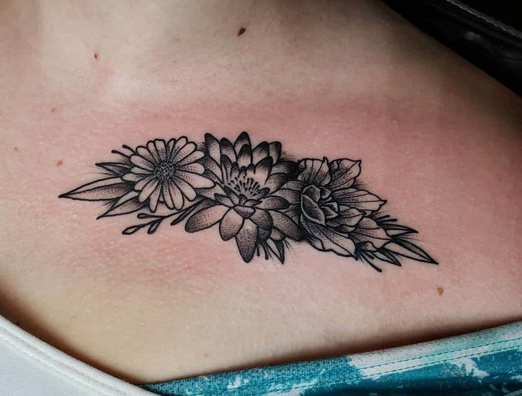 Collar bone tattoo black and grey shading daisy lily carnation bouquet