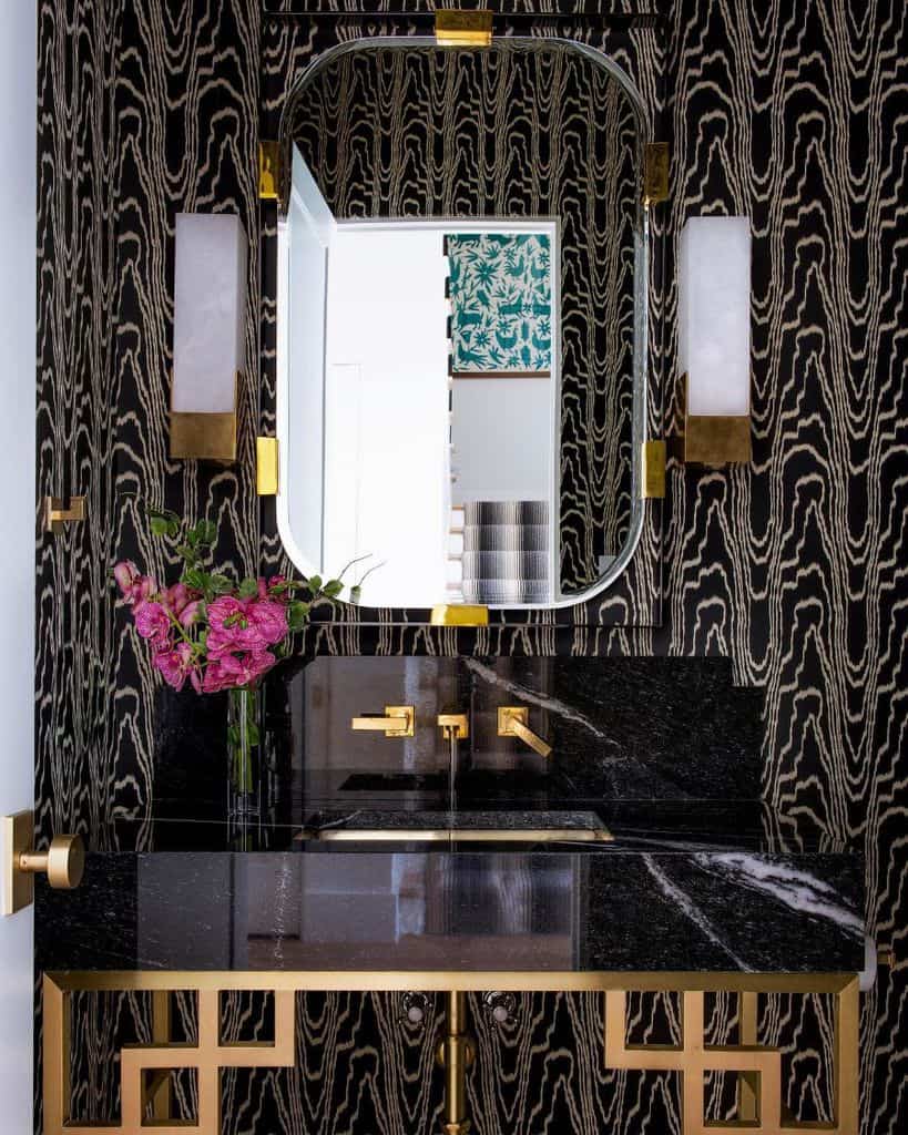 black and white pattern wallpaper powder room with black marble sink