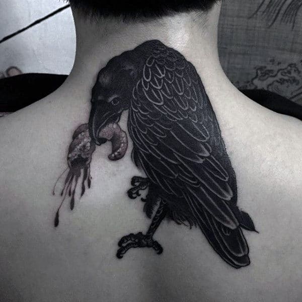 Dark Raven Holding Food Tattoo On Back For Males