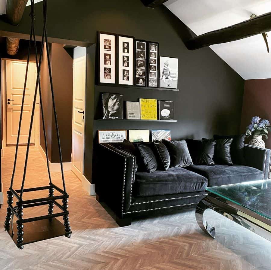 attic style living room with black accent wall and photos 