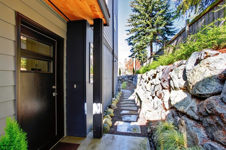 side house walkway stone retaining wall