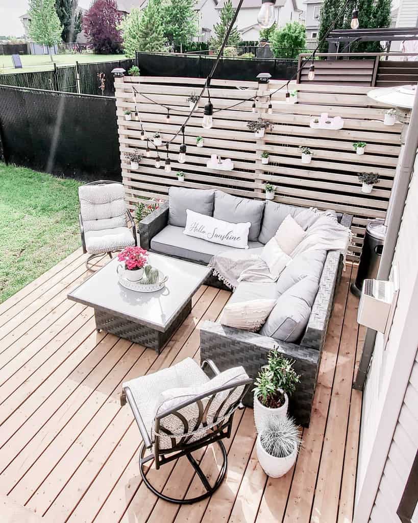 farmhouse deck patio with l-shape couch and wood slat privacy wall