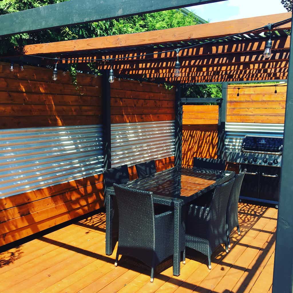 deck patio with wood pergola and wicker table and chairs 