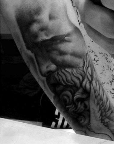deep intense greek god tattoo on arm for guys