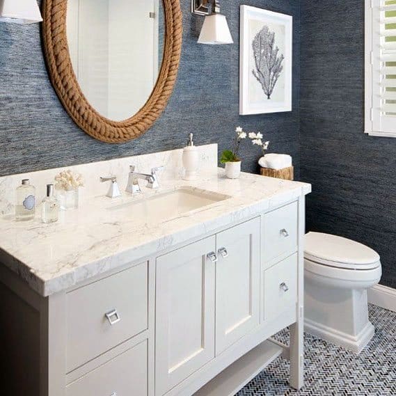 textured bathroom blue wallpaper white vanity 