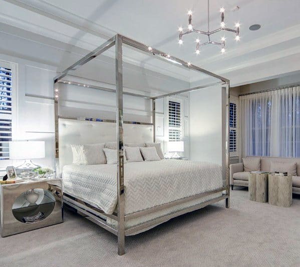 luxury master bedroom with silver four post bed