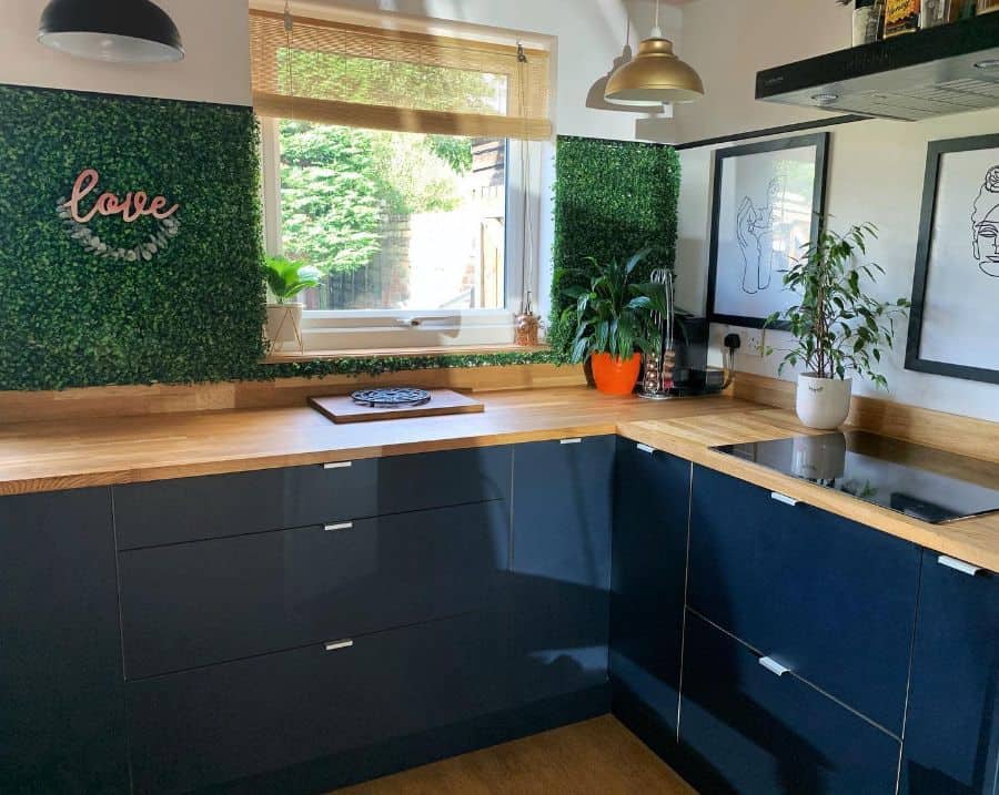 modern corner kitchen with fake grass on walls 