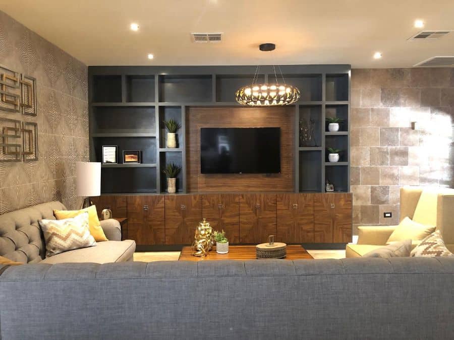 rustic tv room with stone wall