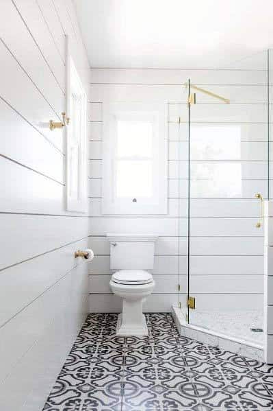white shiplap wall bathroom with white and black tile pattern flooring 