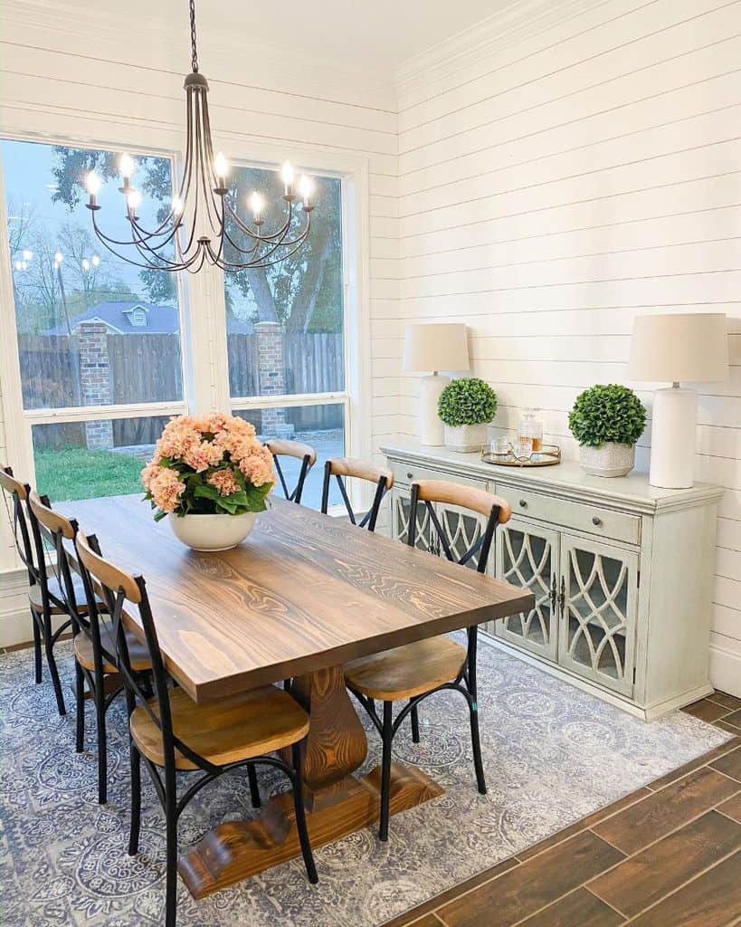 white shiplap dining room with vintage decor and furnishings 